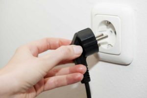 Unplugging the electric stove from the outlet