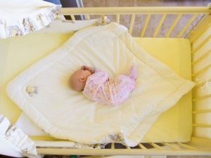 Rocking a baby in a crib with a longitudinal pendulum.