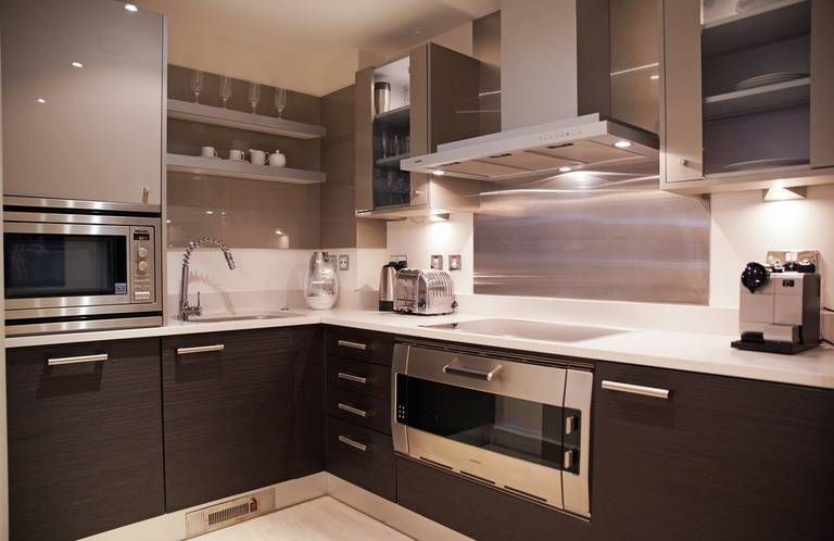 The color of the walls in the kitchen with brown furniture