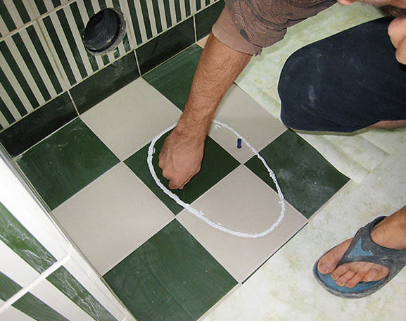 How to attach a toilet to a tile floor