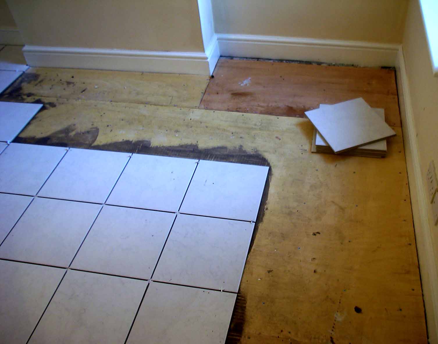 Laying tiles if the wooden floor is in poor condition.