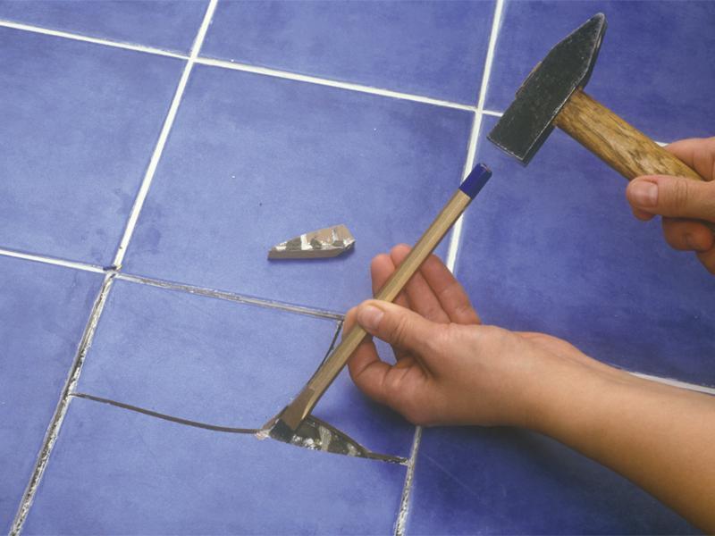 Replacing damaged tiles.