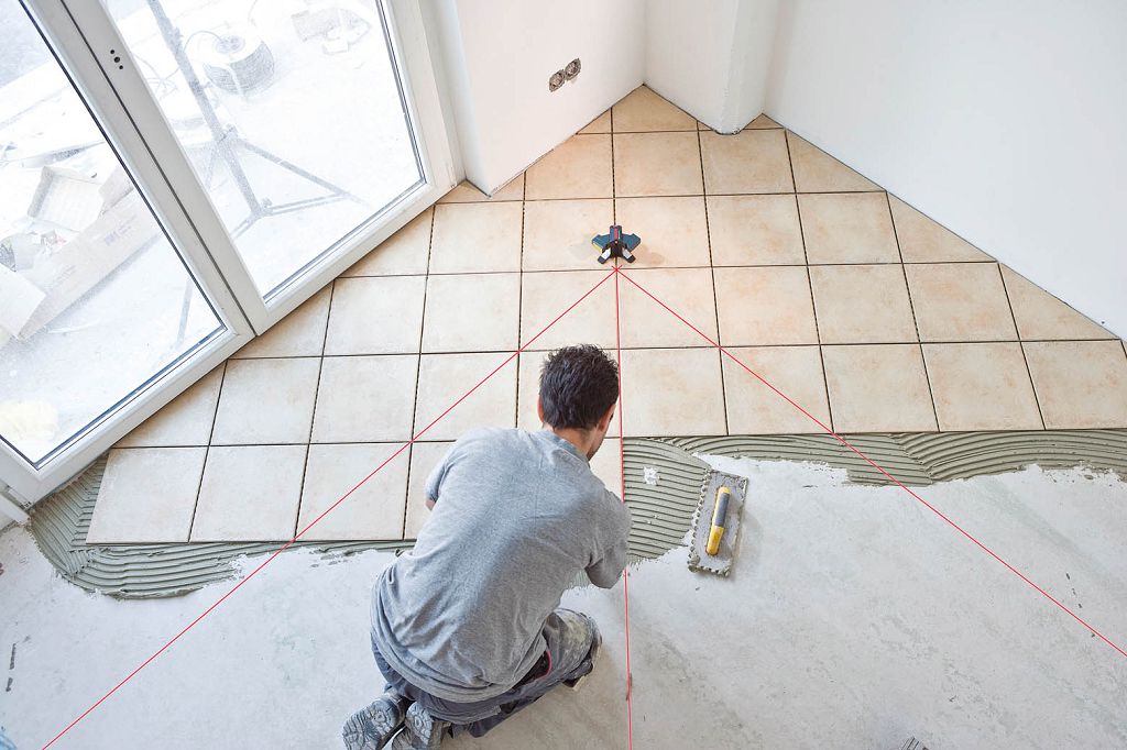 Laying ceramic tiles on the floor 