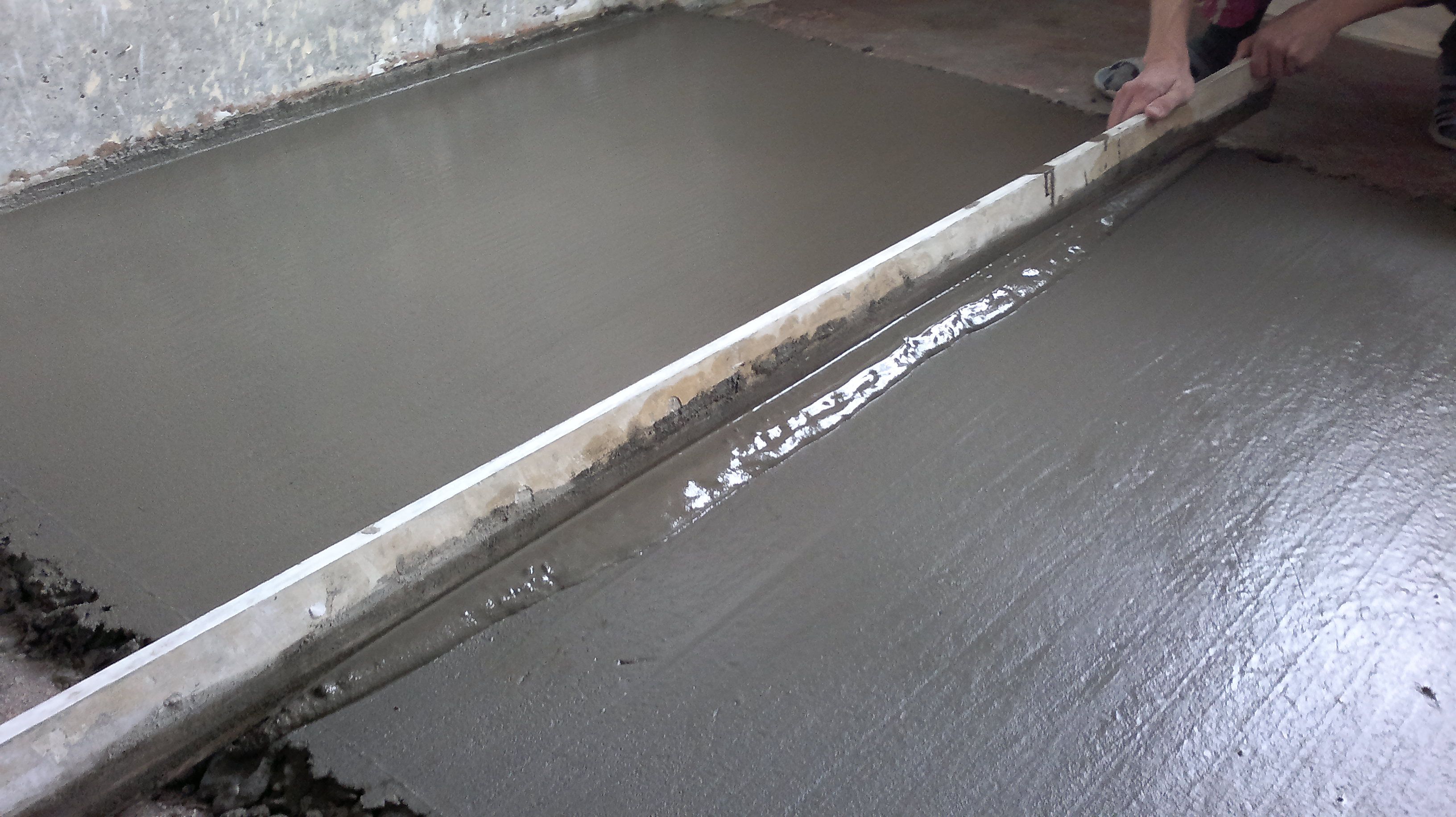 Leveling the concrete base under a warm floor.