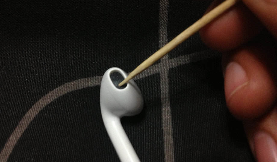 Cleaning headphones with a toothpick.