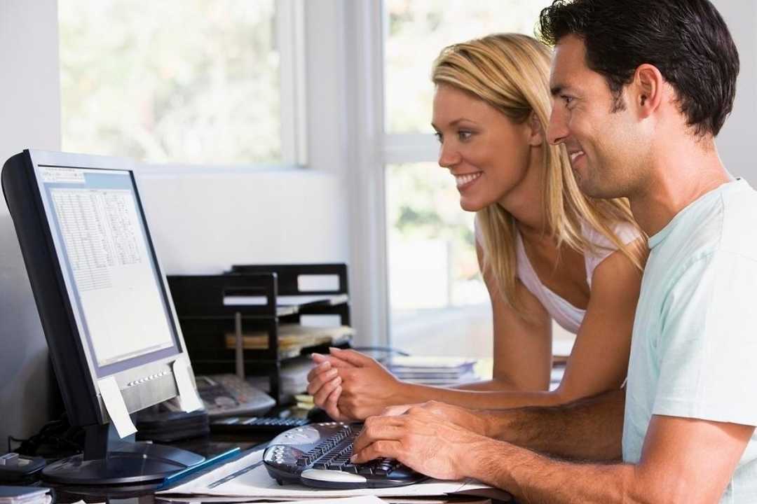 Two users at a computer.