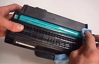 Cleaning the laser printer cartridge.