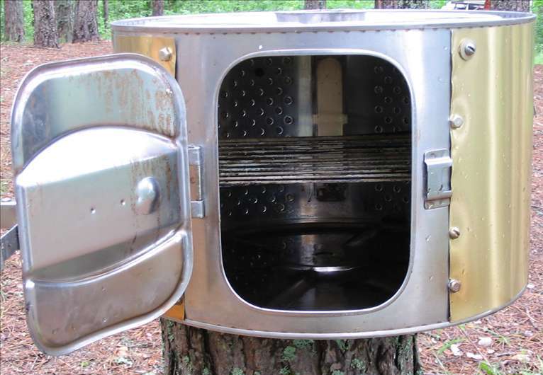 Mini smokehouse made from a washing machine.