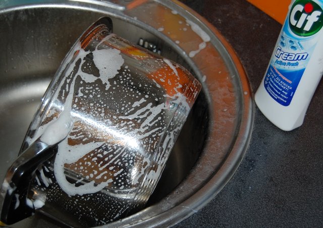 Cleaning the pan from grease using special means.