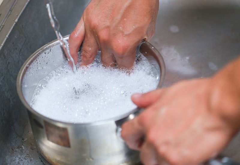 Washing aluminum cookware.