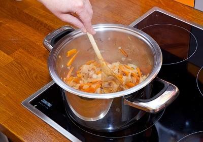 Frying vegetables in a pan.