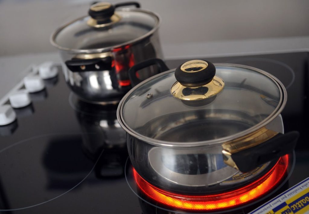 Dishes on a glass-ceramic stove.