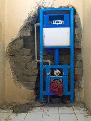 Installation of a wall-hung toilet.