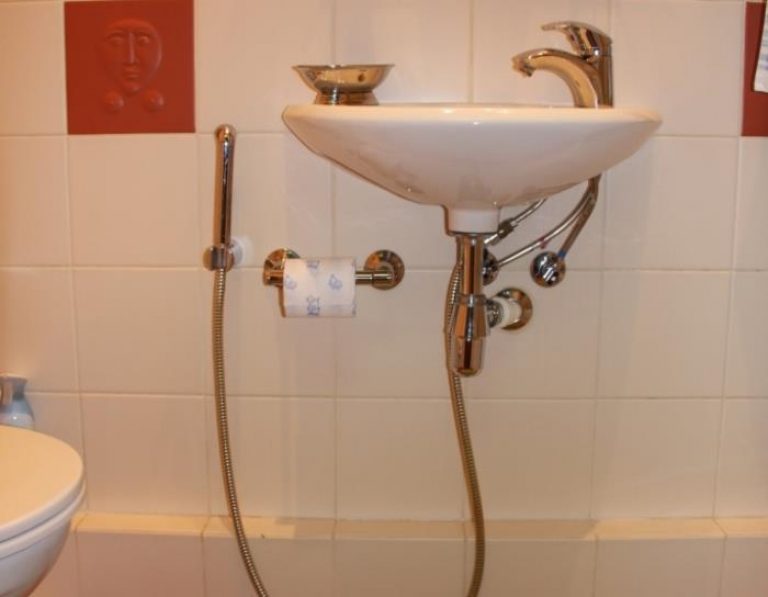 Shower connected to the sink. 