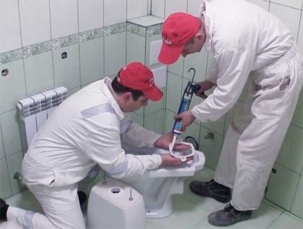 Fixing the toilet with glue.