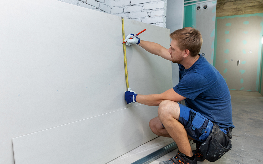 installation of gypsum board sheets to a sloping ceiling